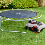 robotic lawn mower under a trapoline