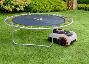 robotic lawn mower under a trapoline
